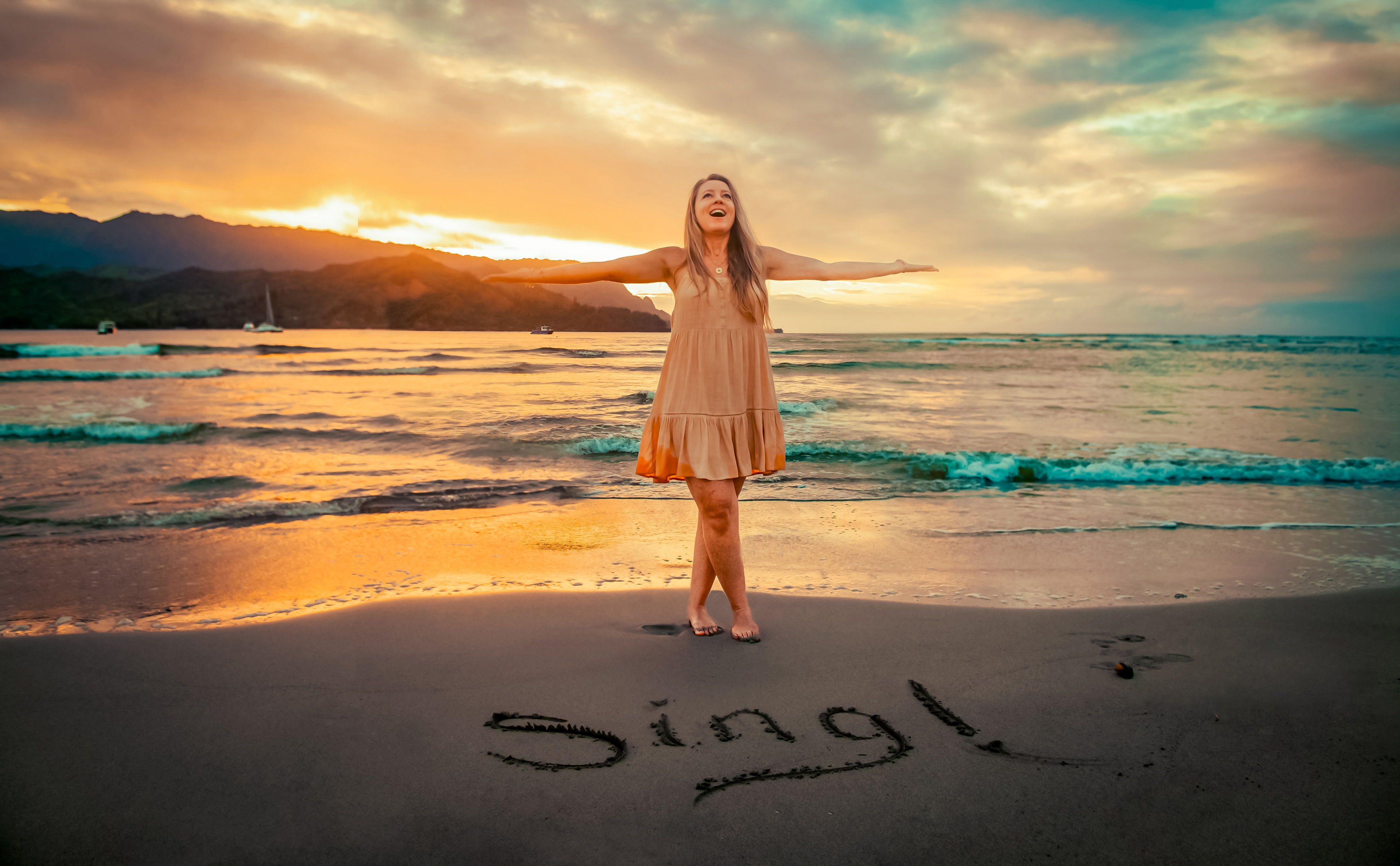 Preeta standing on the beach at sunset